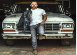 Scotty McCreery standing in front of a truck